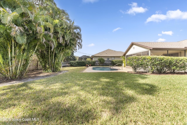 view of yard with a fenced in pool and a patio