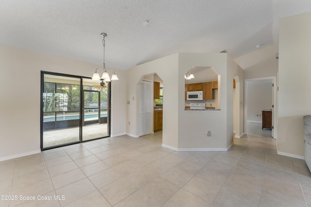 empty room featuring light tile patterned floors and a chandelier