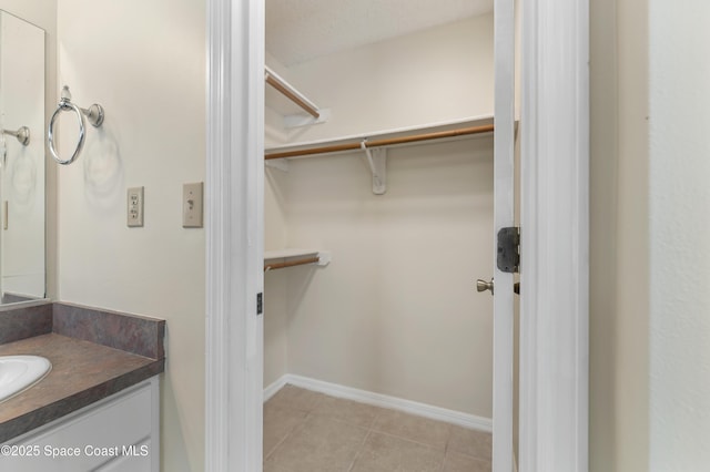 spacious closet featuring sink