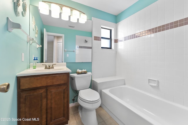 full bathroom featuring tile patterned flooring, vanity, tiled shower / bath combo, and toilet