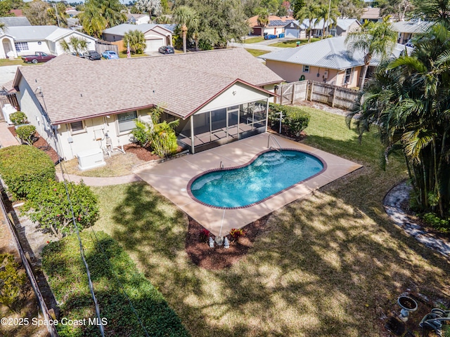 view of pool featuring a sunroom, a patio area, and a lawn