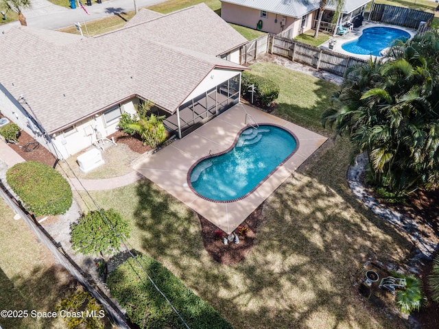 view of pool with a lawn and a patio area