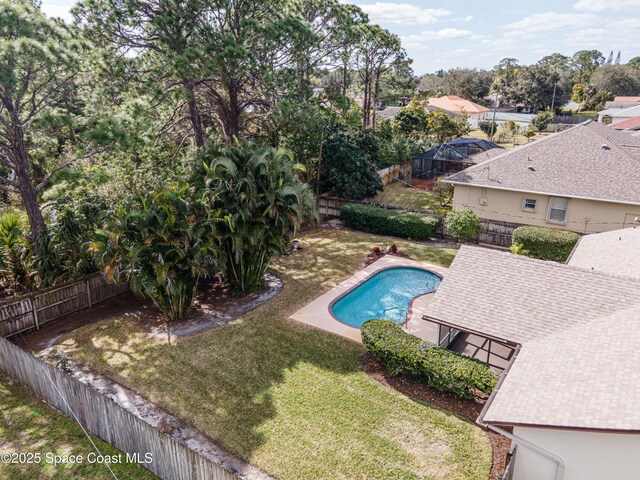 view of pool featuring a lawn and a patio