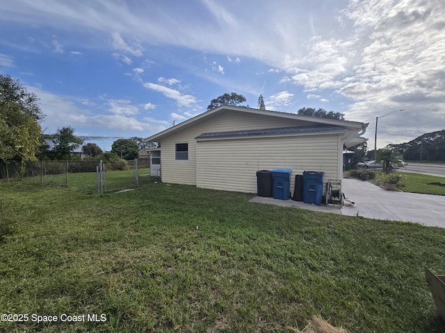 view of side of property with a yard and a patio