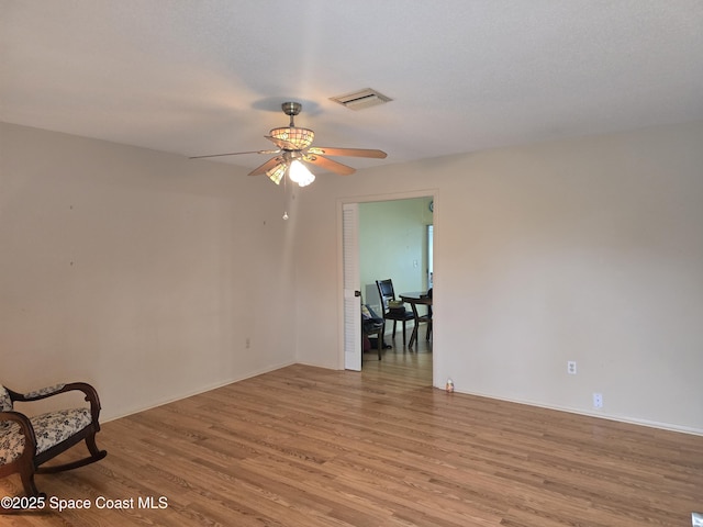 spare room featuring ceiling fan and light hardwood / wood-style flooring