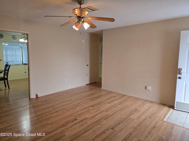 unfurnished room featuring light wood-type flooring and ceiling fan