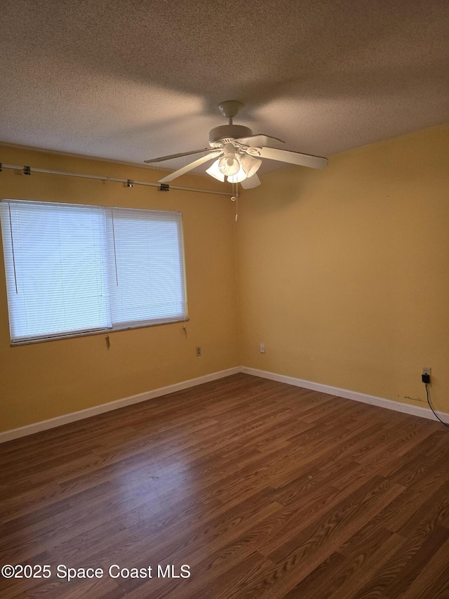 unfurnished room with a textured ceiling, ceiling fan, and dark hardwood / wood-style floors