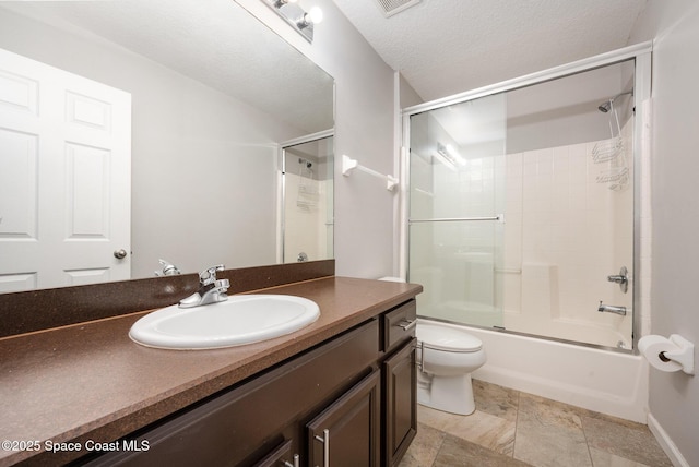 full bathroom with vanity, enclosed tub / shower combo, a textured ceiling, and toilet