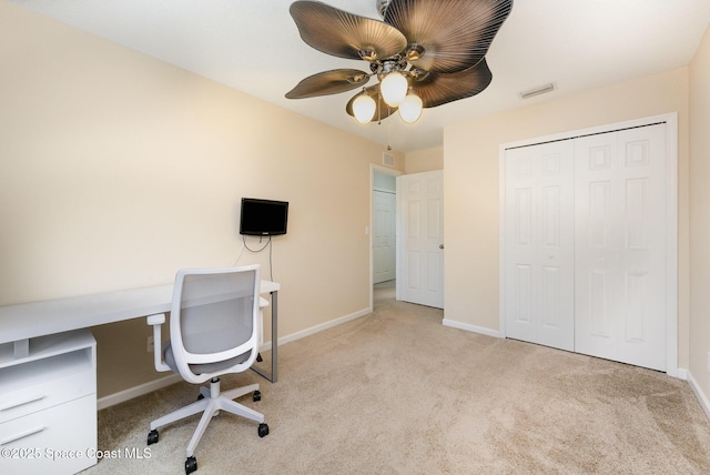 unfurnished office with ceiling fan and light carpet