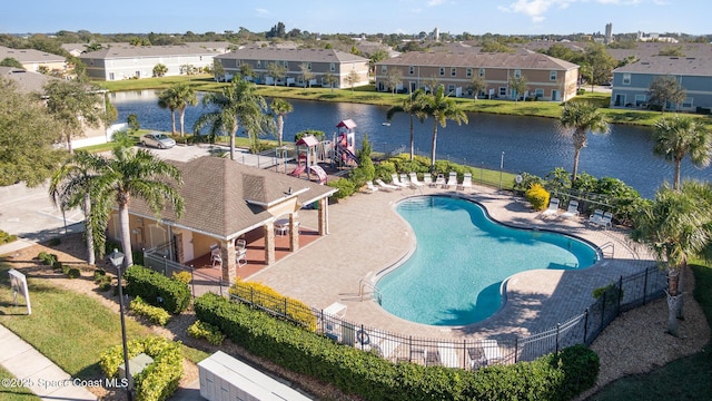 view of pool featuring a water view and a patio area