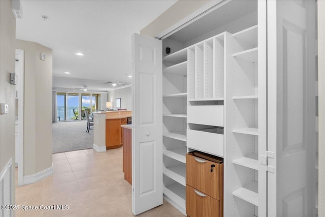 spacious closet featuring light tile patterned floors and ceiling fan