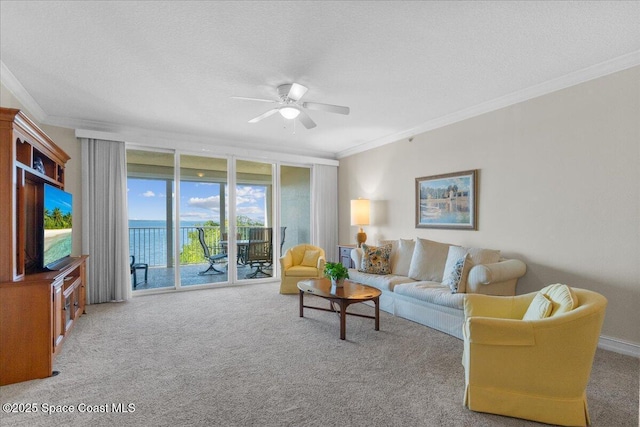 living room featuring light colored carpet, ornamental molding, ceiling fan, and a textured ceiling