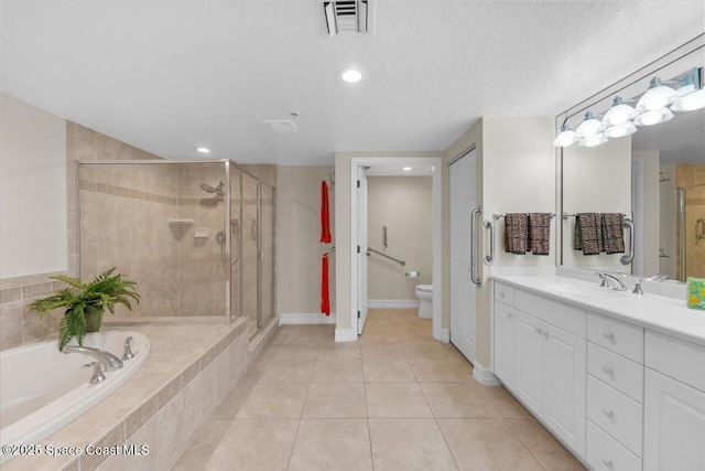 full bathroom with vanity, a textured ceiling, tile patterned floors, independent shower and bath, and toilet