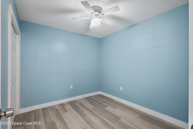 empty room with light hardwood / wood-style floors and ceiling fan