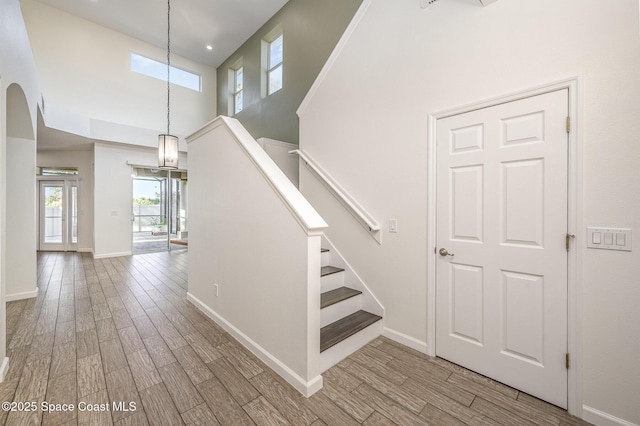 staircase featuring a high ceiling