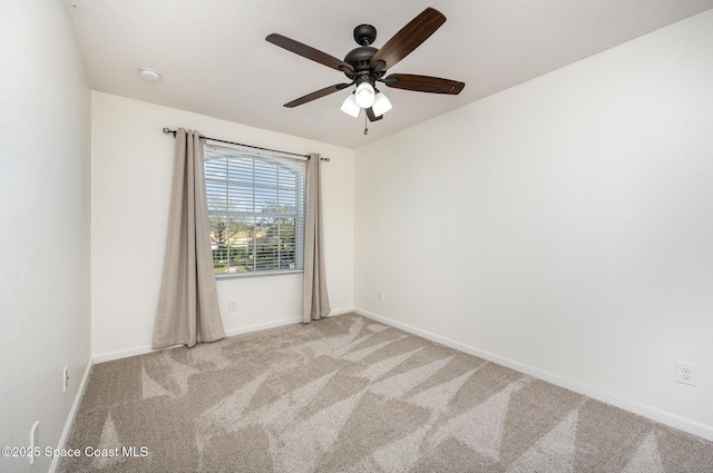 carpeted empty room featuring ceiling fan