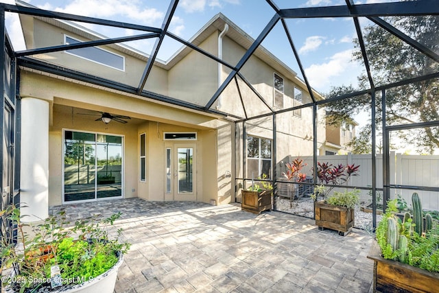 view of patio with glass enclosure and ceiling fan