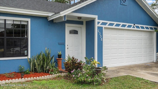 doorway to property featuring a garage