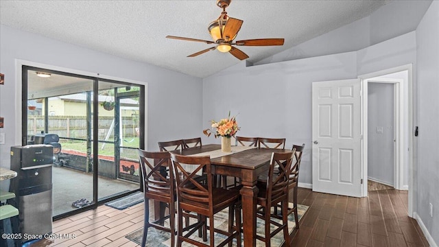 dining space with a textured ceiling, ceiling fan, and lofted ceiling