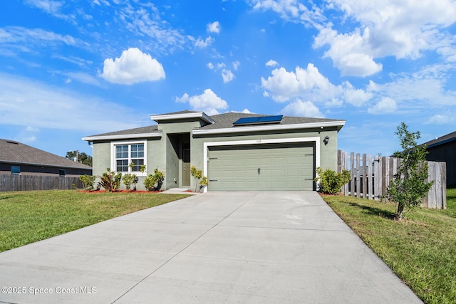 view of front of home featuring solar panels, a garage, and a front yard