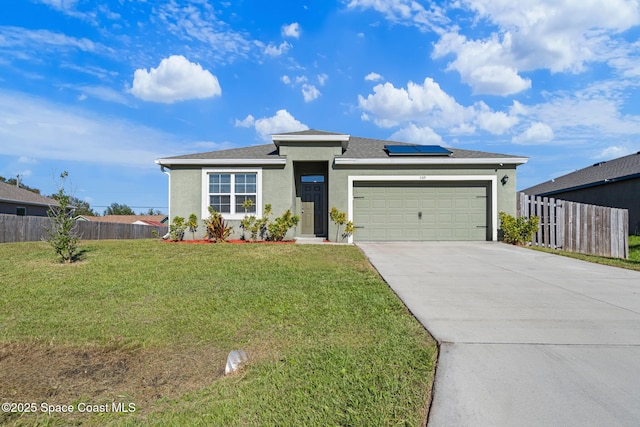 view of front of property featuring solar panels, a garage, and a front lawn