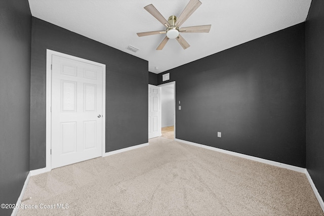 unfurnished bedroom featuring ceiling fan and light colored carpet