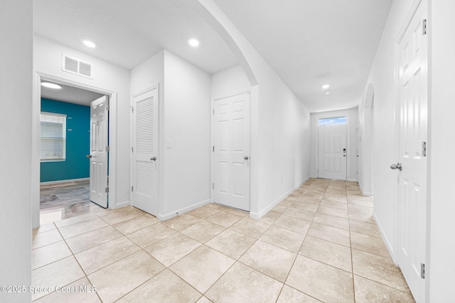 hallway with light tile patterned floors