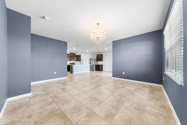 unfurnished living room featuring light tile patterned floors and a notable chandelier