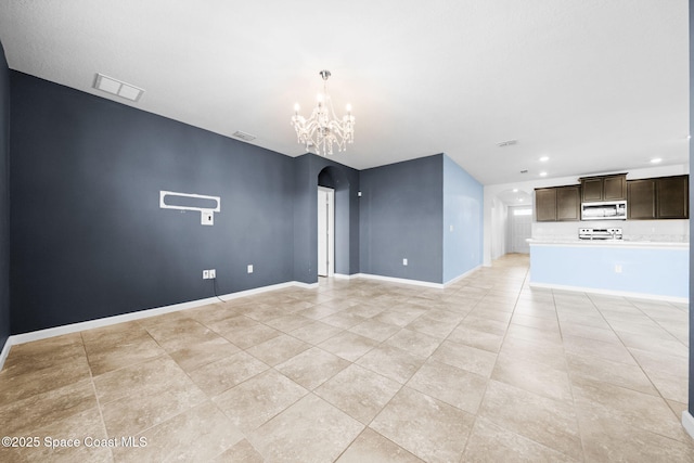 unfurnished living room with a chandelier and light tile patterned flooring