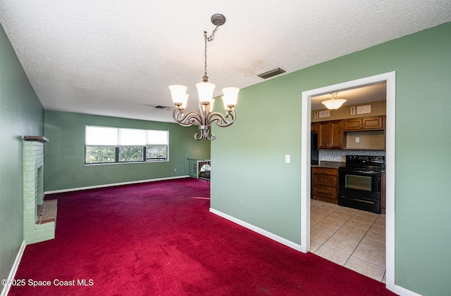 unfurnished dining area featuring a textured ceiling, light tile patterned floors, and a chandelier