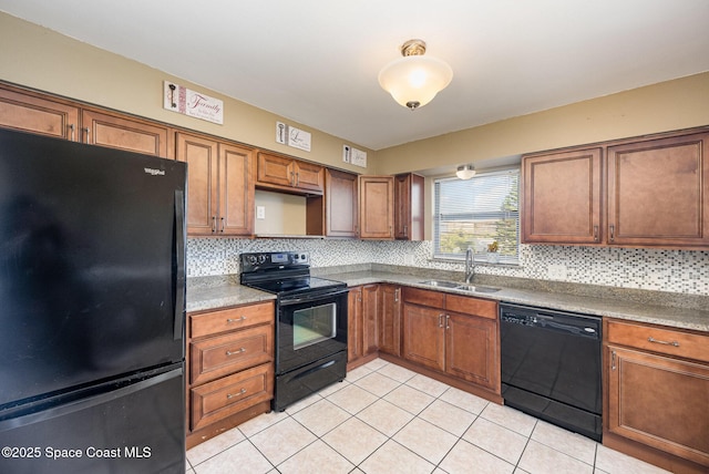 kitchen with backsplash, light tile patterned flooring, black appliances, and sink