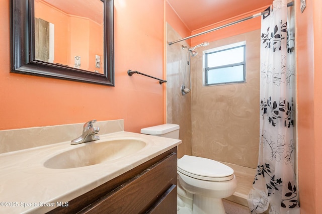 bathroom featuring toilet, walk in shower, and vanity