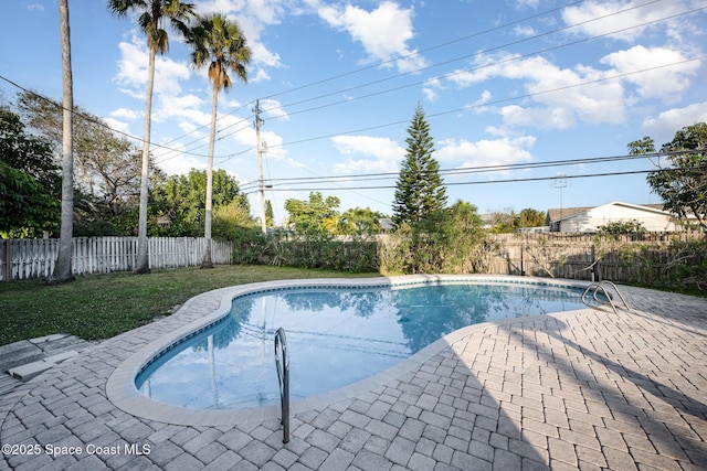 view of swimming pool with a yard and a patio area