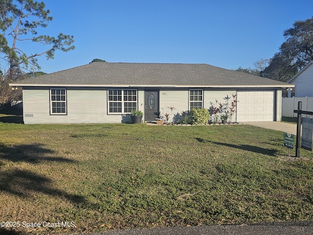 ranch-style house featuring a garage and a front lawn