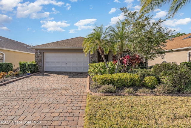 view of front of property featuring a garage and a front lawn