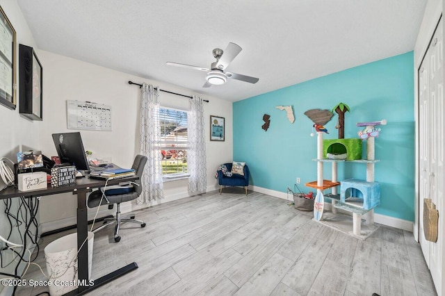 home office featuring ceiling fan and light hardwood / wood-style floors