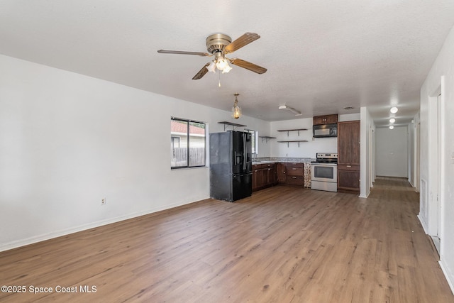 kitchen with ceiling fan, dark brown cabinets, black appliances, a textured ceiling, and light wood-type flooring