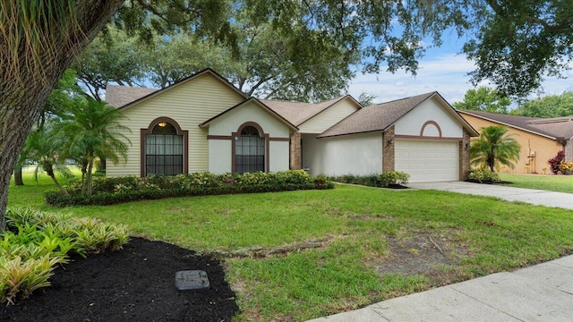 single story home featuring a front yard and a garage