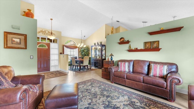 living room featuring light tile patterned floors, a textured ceiling, an inviting chandelier, and high vaulted ceiling