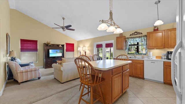 kitchen with dishwasher, a center island, pendant lighting, and vaulted ceiling