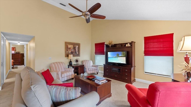 living room featuring ceiling fan, high vaulted ceiling, and light carpet