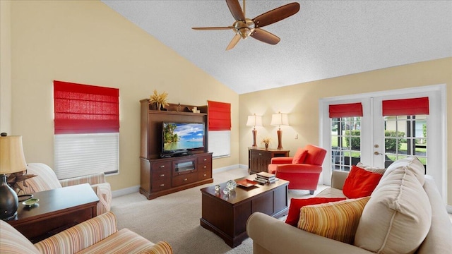 carpeted living room with ceiling fan, vaulted ceiling, a textured ceiling, and french doors