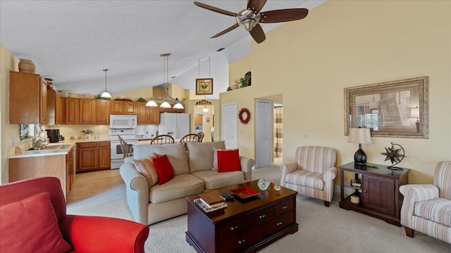 living room with ceiling fan, sink, high vaulted ceiling, a textured ceiling, and light carpet