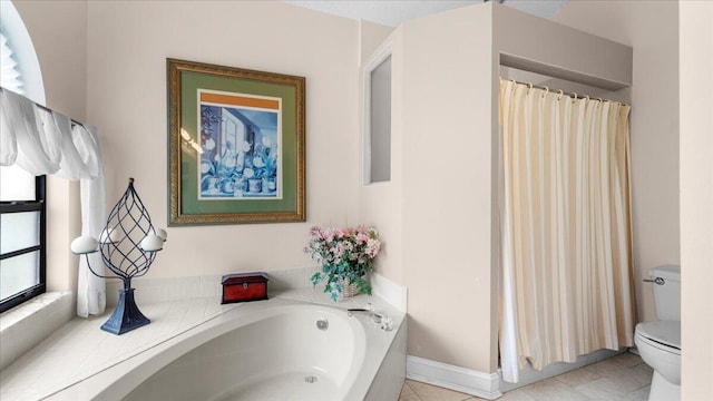 bathroom featuring tile patterned floors, a washtub, and toilet