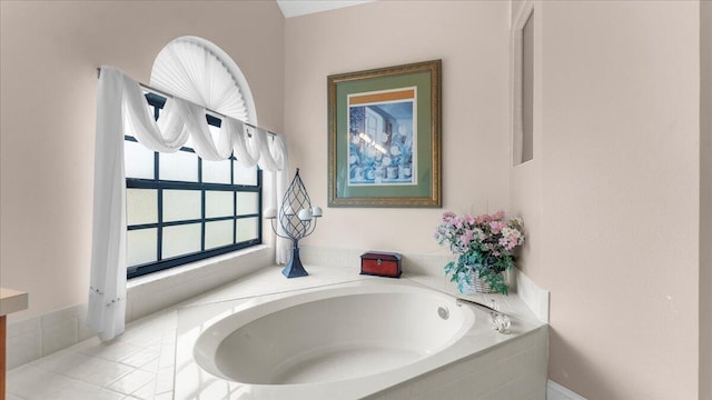 bathroom with tile patterned floors and tiled bath