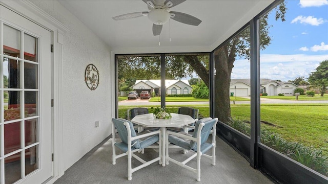 sunroom featuring ceiling fan and plenty of natural light