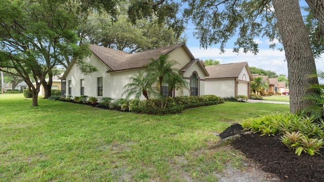 view of side of property with a garage and a yard