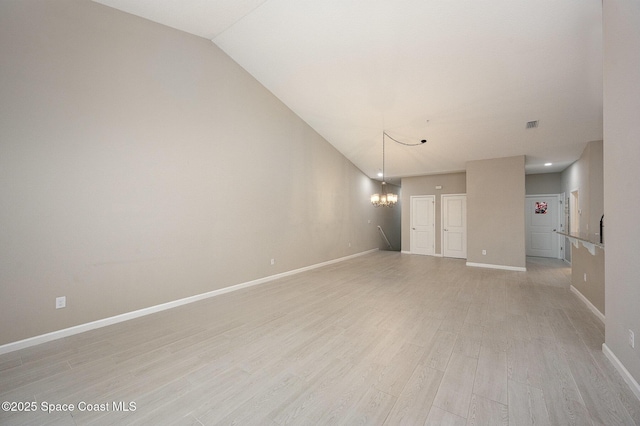 unfurnished room with light hardwood / wood-style flooring and a chandelier