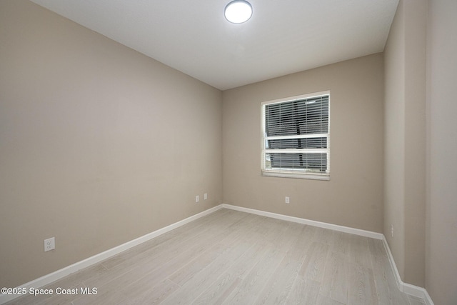 spare room featuring light wood-type flooring