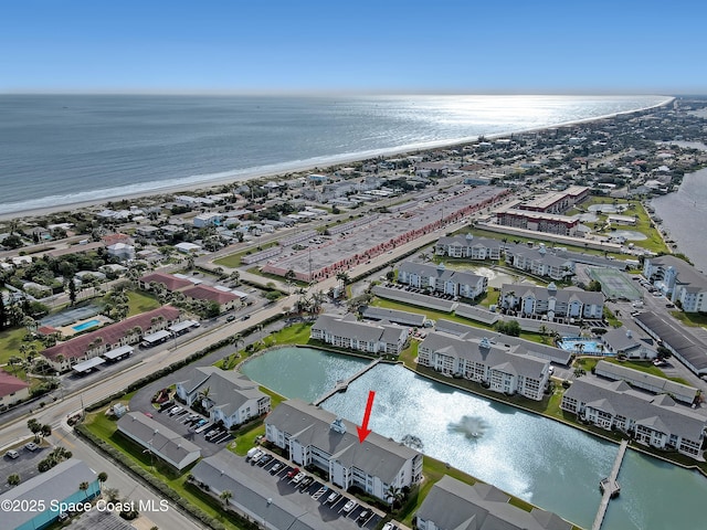 bird's eye view featuring a water view and a view of the beach